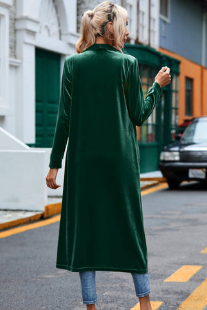 Dark green velvet duster coat with long sleeves, open front, and a relaxed fit.