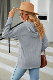 Gray textured knit hooded top with long sleeves.