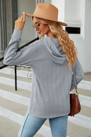 Gray textured knit hooded top with long sleeves.