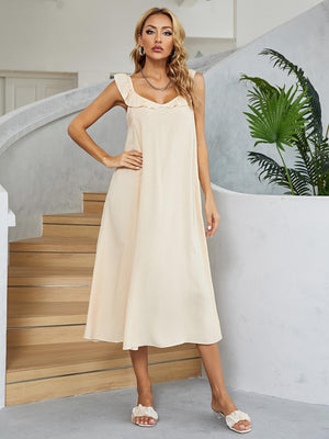 Cream midi slip dress in 100% rayon with ruffled straps and A-line cut.