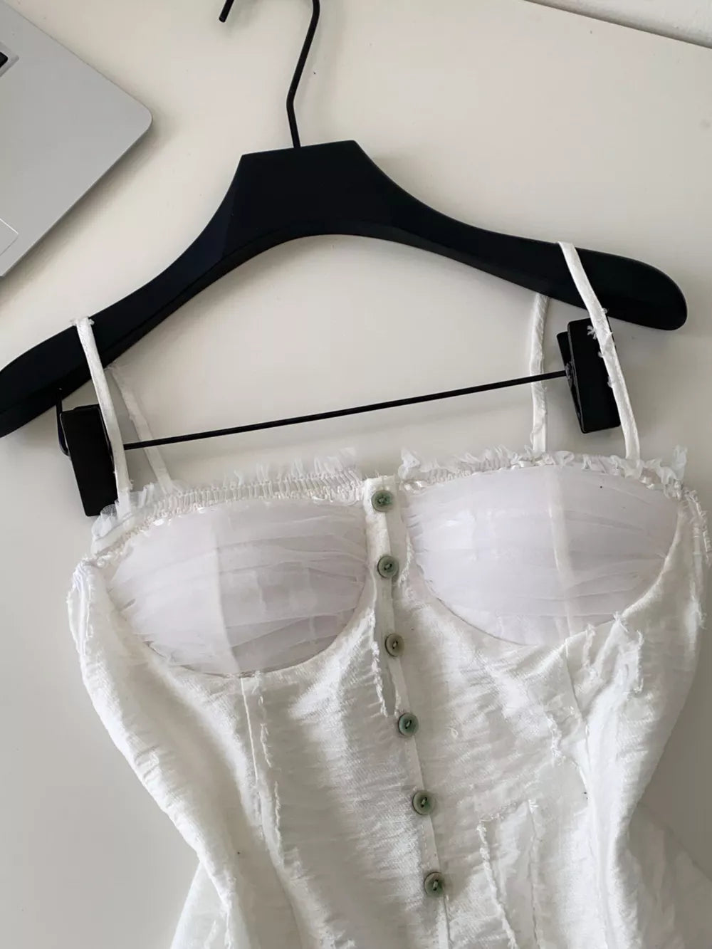 White lace ruffle hem tank top with button front and sheer bust detail