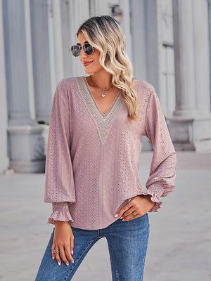 Blush pink eyelet blouse with lace trim V-neck and ruffled cuffs.