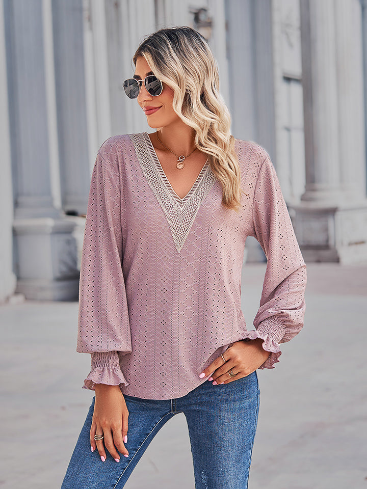 Blush pink eyelet blouse with lace trim V-neck and ruffled cuffs.
