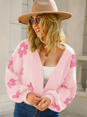 Blush pink fuzzy acrylic cardigan with pink floral print and puff sleeves.