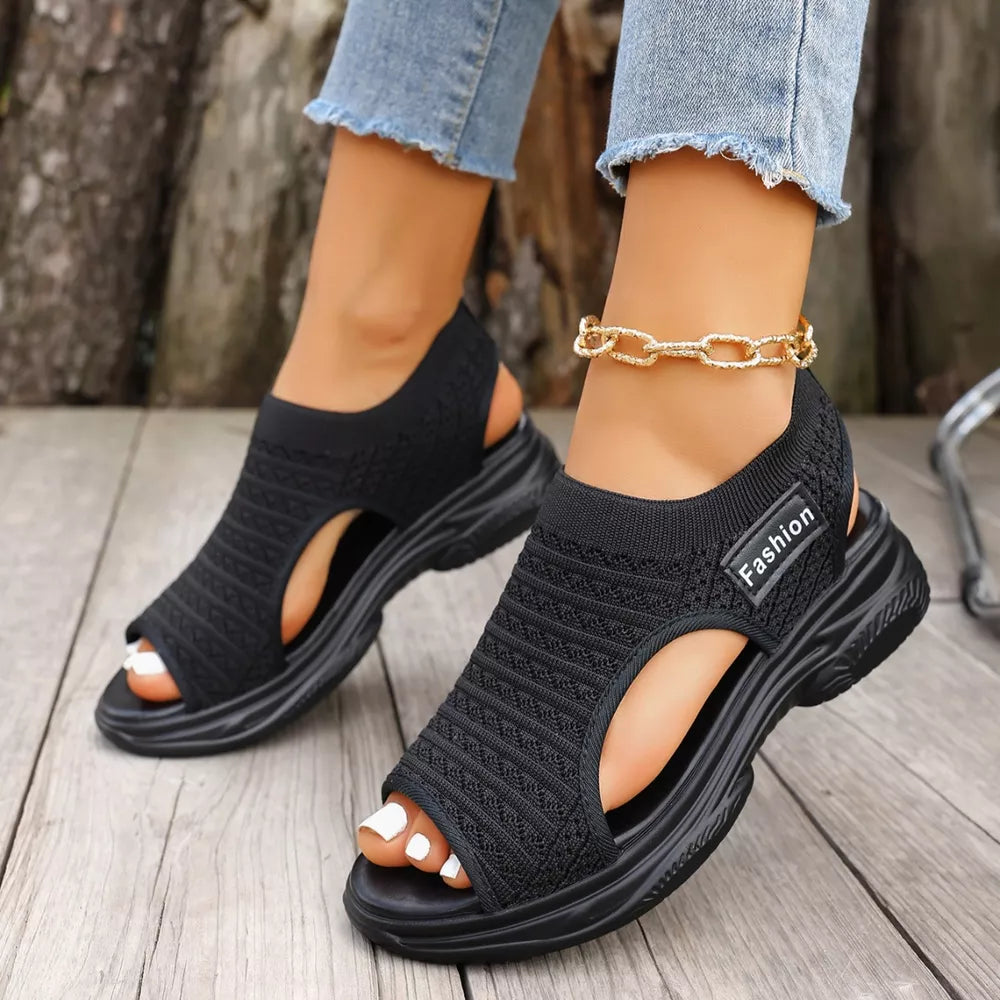 Black sporty chunky platform sandals with breathable knit upper and "Fashion" detail.