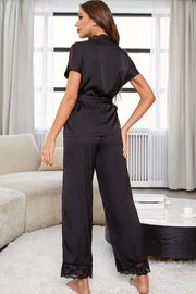 Black silk wrap pajama set with lace trim on sleeves and pant cuffs