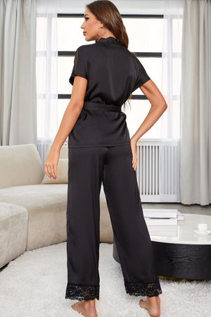 Black silk wrap pajama set with lace trim on sleeves and pant cuffs