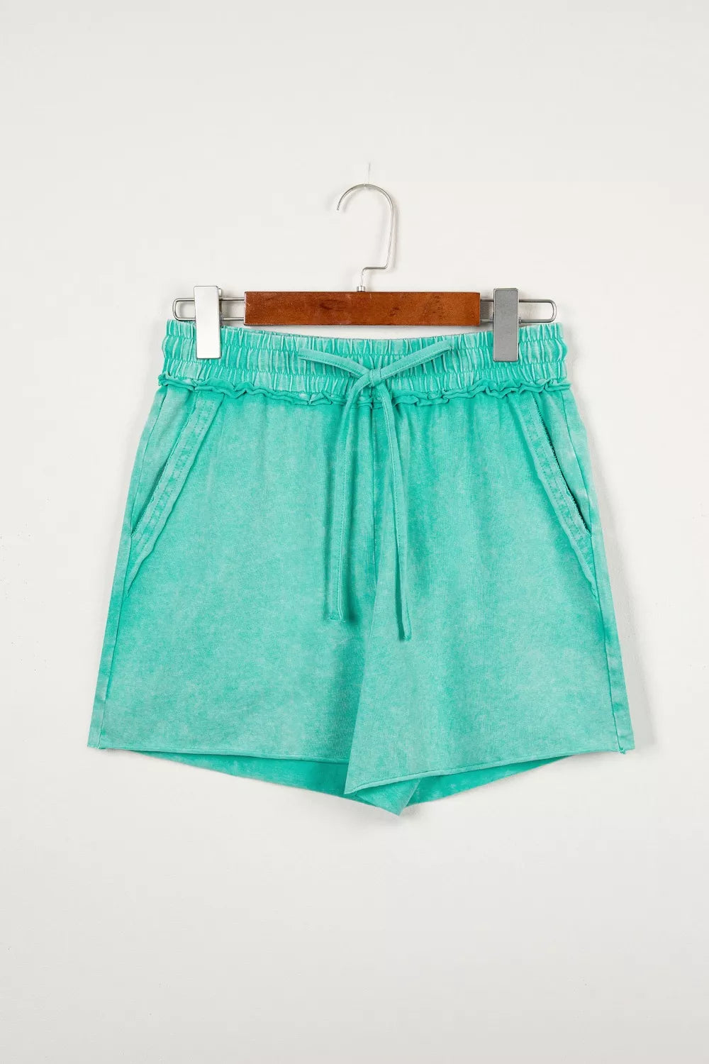 Green mineral washed cotton shorts with drawstring waist and pockets.