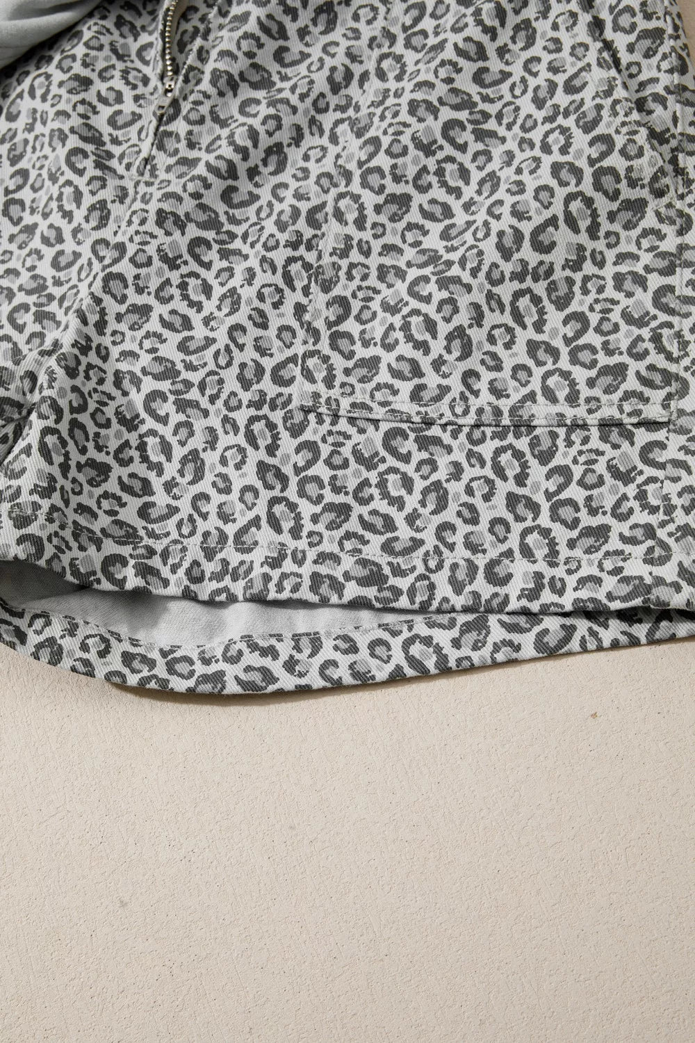 Denim shorts with leopard print in grey and white, featuring a pocket detail.