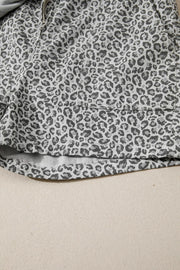 Denim shorts with leopard print in grey and white, featuring a pocket detail.