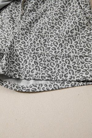 Denim shorts with leopard print in grey and white, featuring a pocket detail.