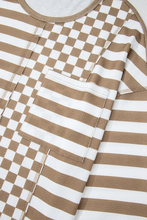 Camel and white checkered and striped knit top with a chest pocket.