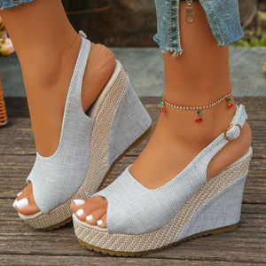 Gray woven espadrille wedge sandals with peep toe and slingback strap.