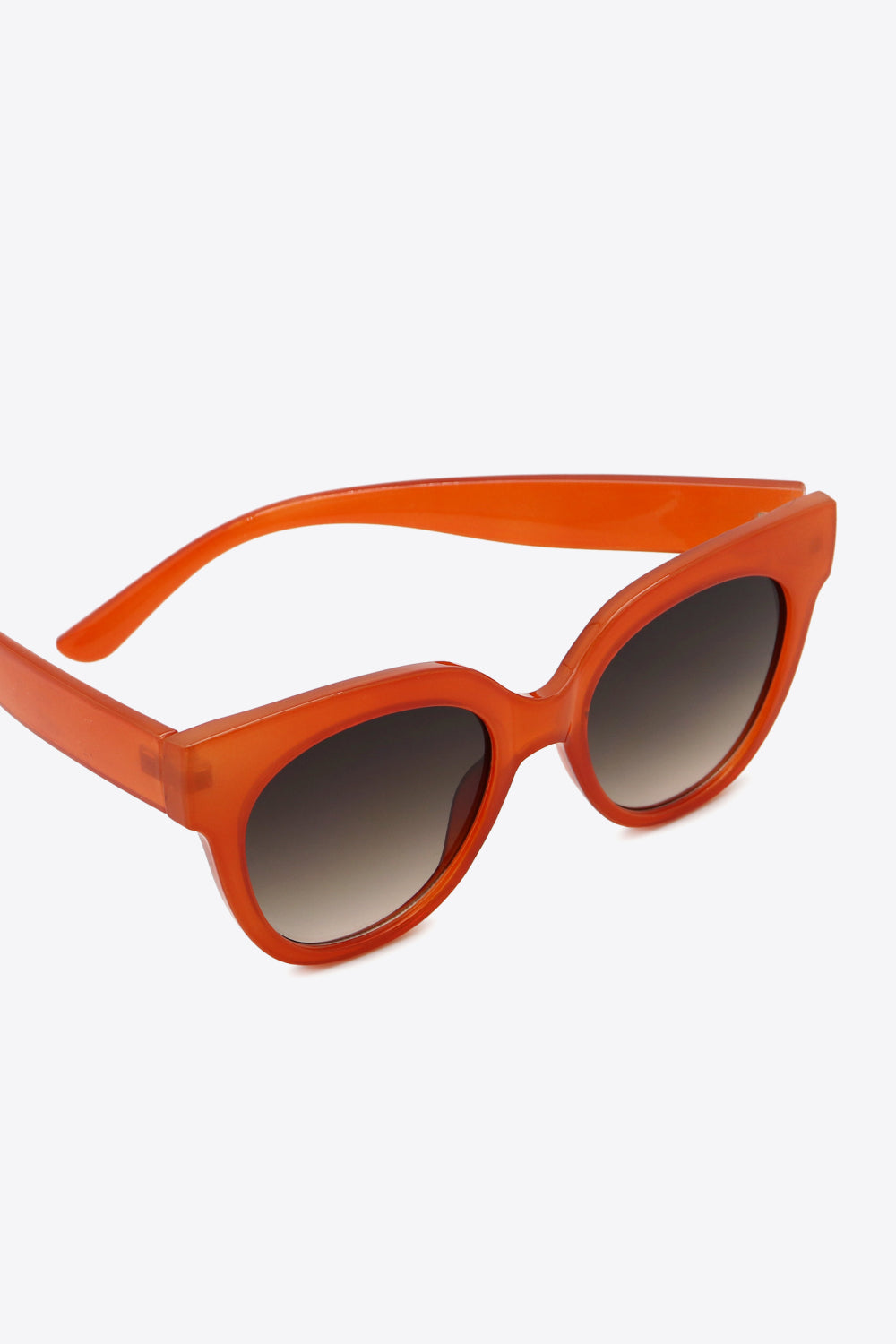 Sunset cat-eye sunglasses in deep red with gradient lenses.