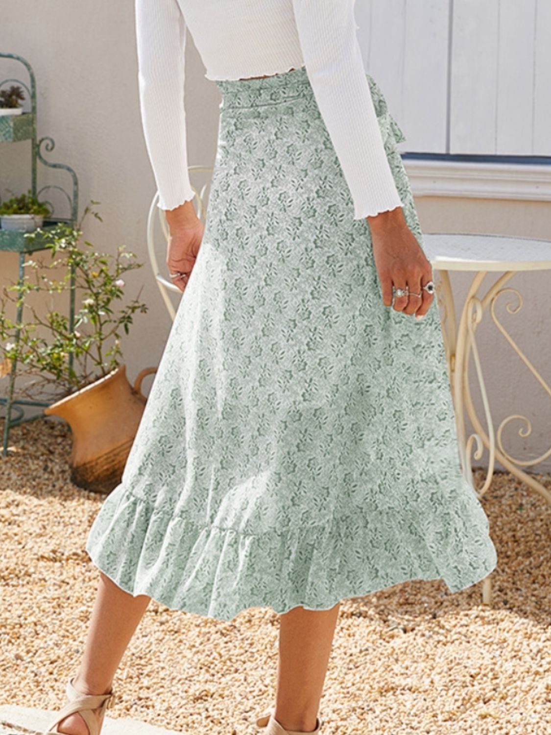 Asymmetric wrap skirt in Gum Leaf with a delicate leaf print and ruffled hem.