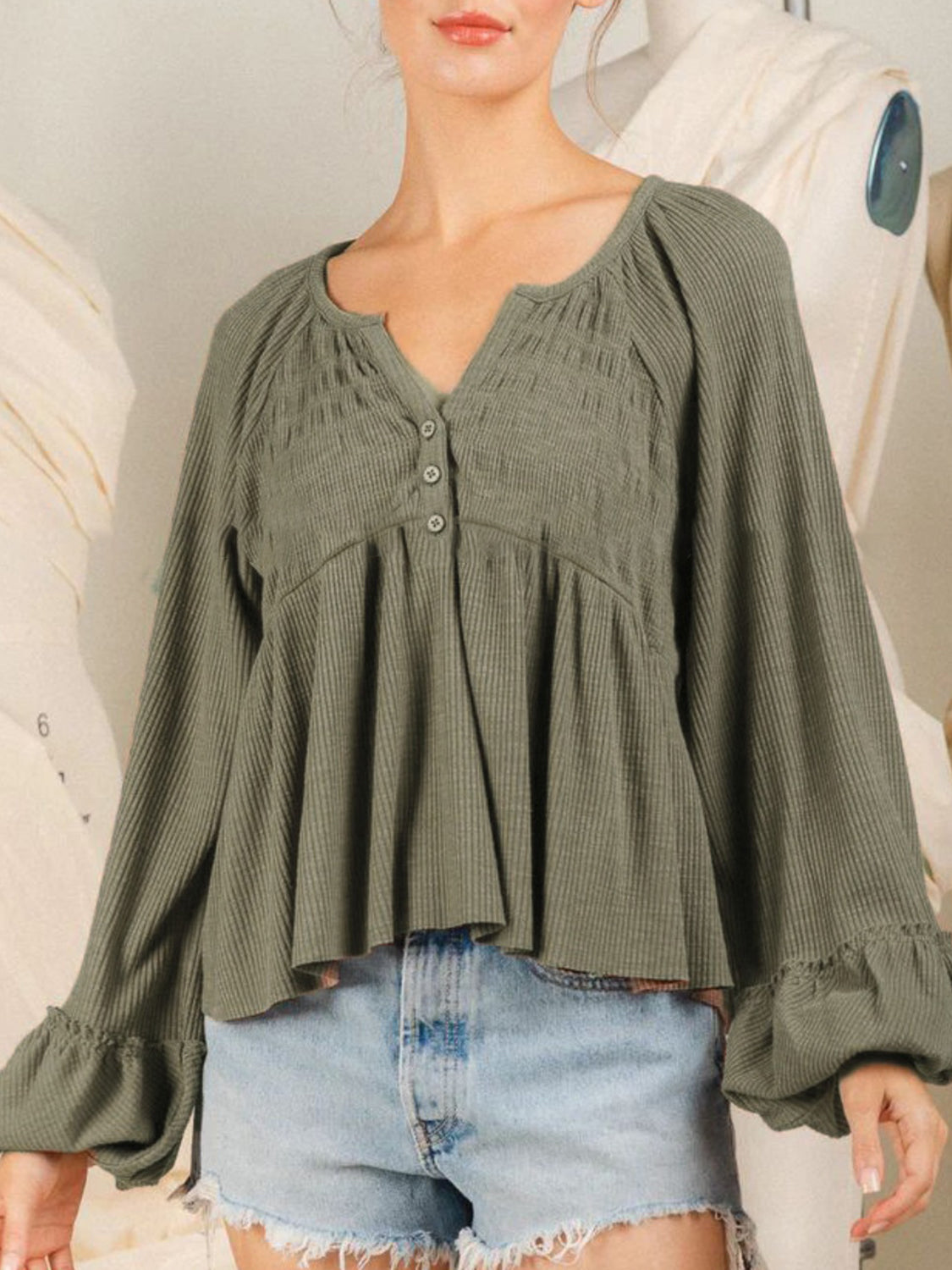 Textured ribbed peplum blouse in matcha green with button front and ruffled cuffs