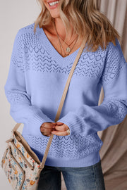 Light blue perforated knit V-neck pullover sweater with open stitch detail on yoke and sleeves.