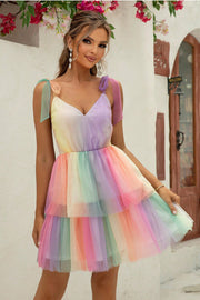 Rainbow tulle mini dress with tie straps and tiered skirt.