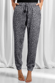 Jogger trousers in dark gray with a black leopard print, drawstring waist, and cuffed ankles.