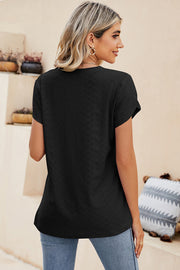 Black eyelet sleeve detail V-neck top with textured fabric.