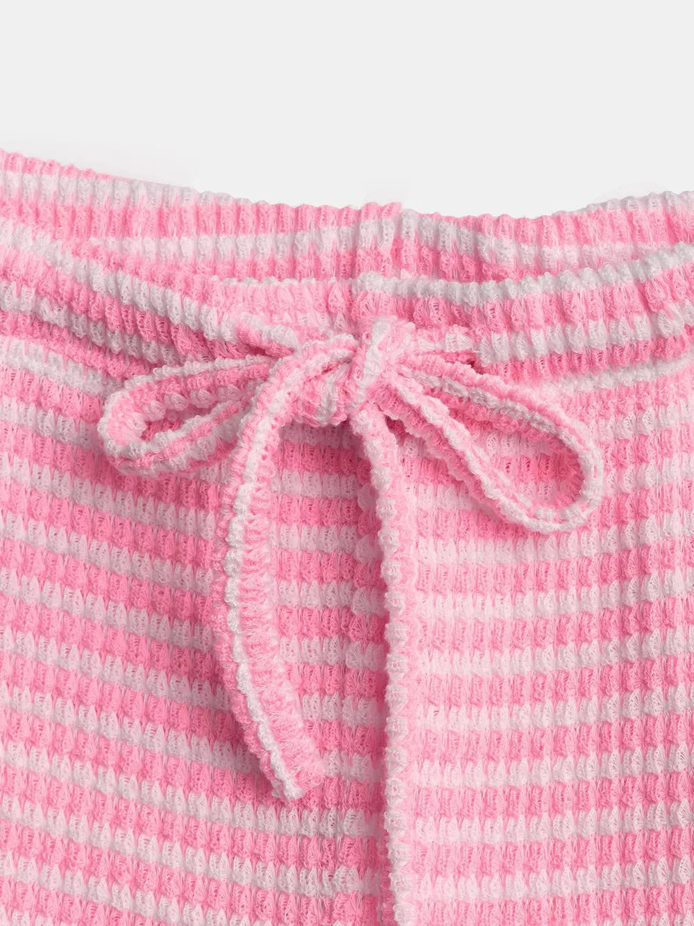 Pink and white striped maternity pants with a drawstring waist and textured fabric.