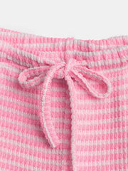 Pink and white striped maternity pants with a drawstring waist and textured fabric.