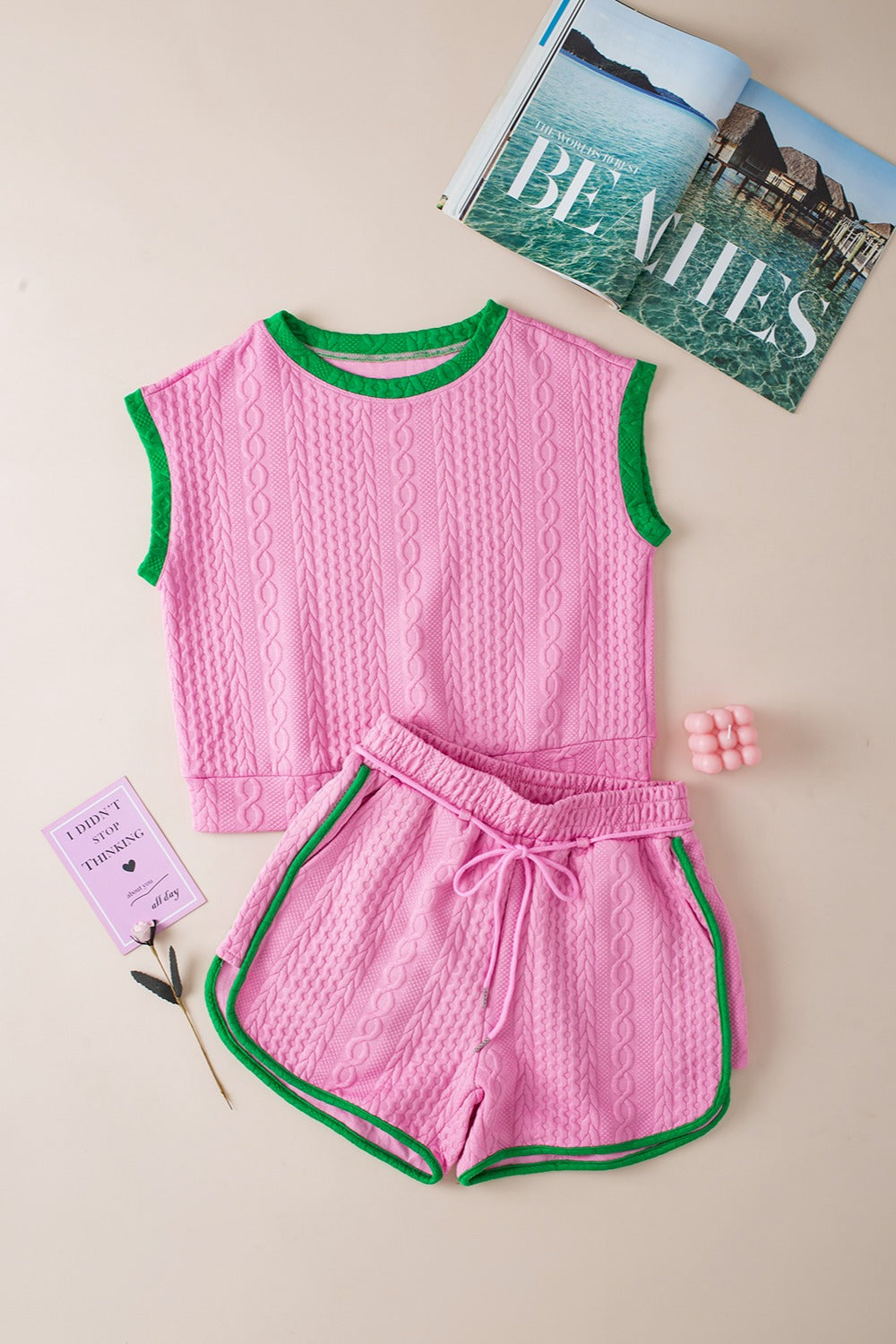 Pink cable knit loungewear set with green trim, featuring a sleeveless top and drawstring shorts.