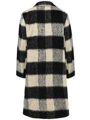 Checked plaid cocoon coat in black and cream with a fuzzy texture.