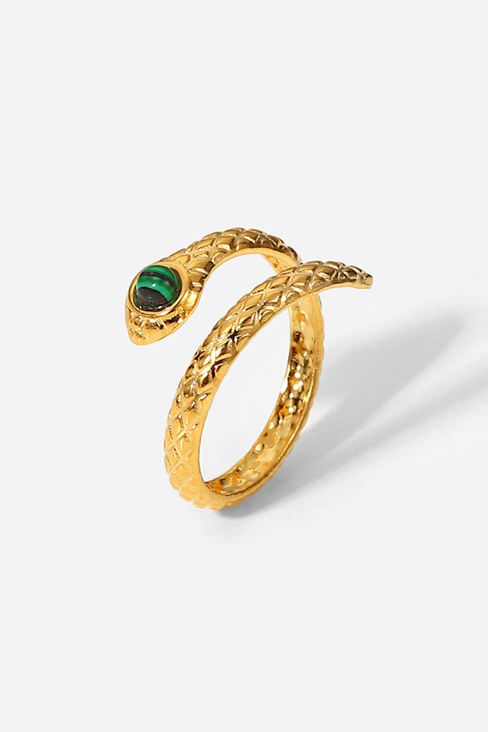 Gold serpentine ring with malachite eye detail and textured band
