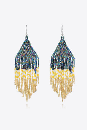 Geometric fringe beaded earrings with multicolor, yellow, white, and gold beads.