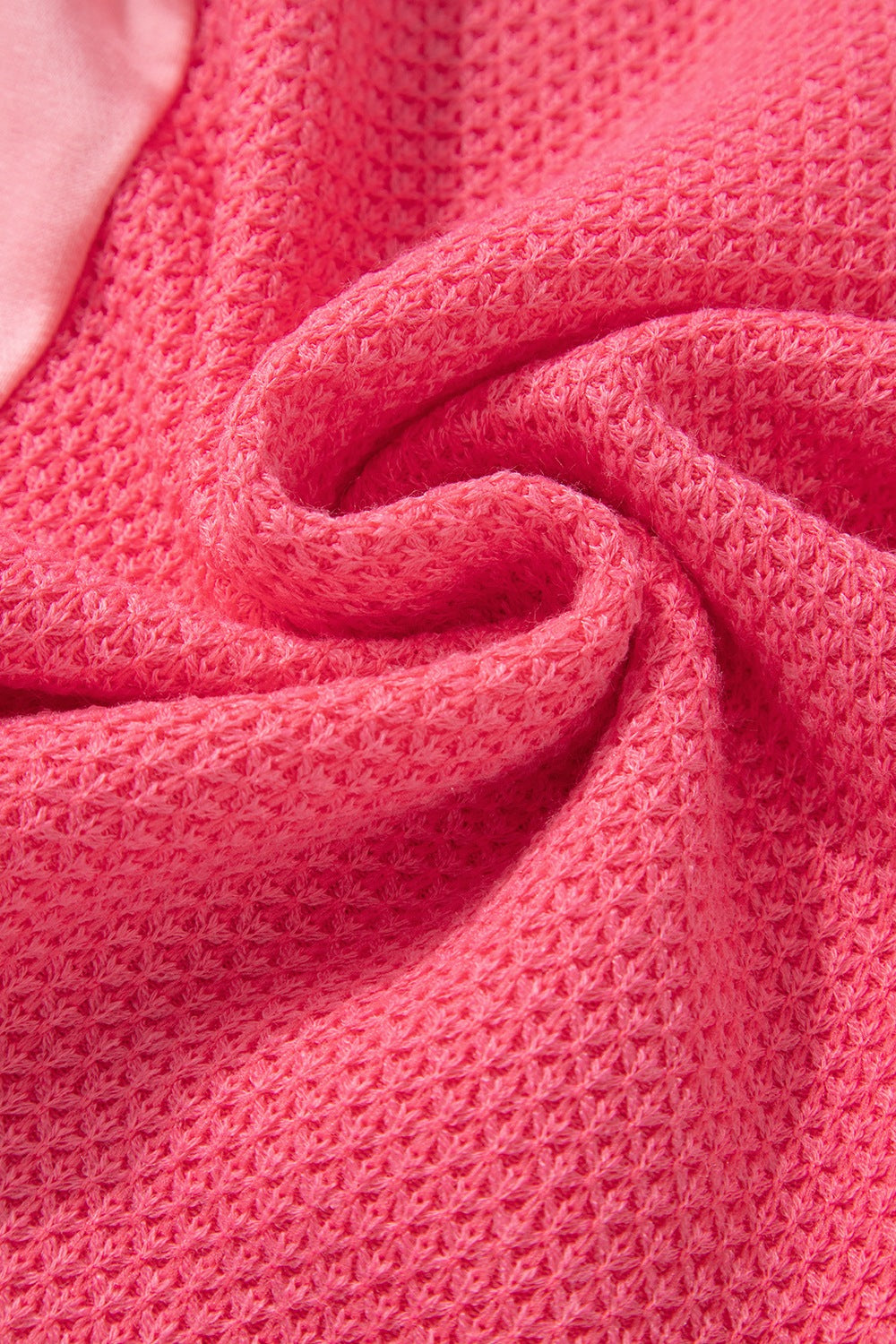 Blush pink waffle knit shacket with textured fabric detail.