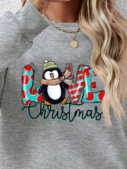 Grey sweatshirt with festive penguin graphic and Christmas text, red polka dots, red and white stripes.