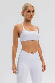 White crisscross back sports bra with a square neckline and thin straps.
