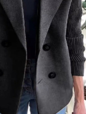 Gray double-breasted wool blend blazer with black buttons and ribbed sleeves.