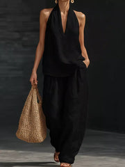 Black halter neck top with flowing wide-leg pants set, a breezy casual outfit.