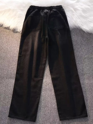 Black vintage wash wide-leg jeans with drawstring waist and back pockets.