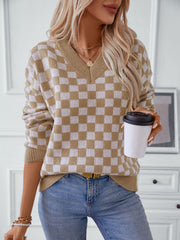 Checkerboard knit v-neck pullover sweater in camel and white, with long sleeves.