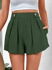 Dark green high-waisted pleated shorts with button detail and pockets