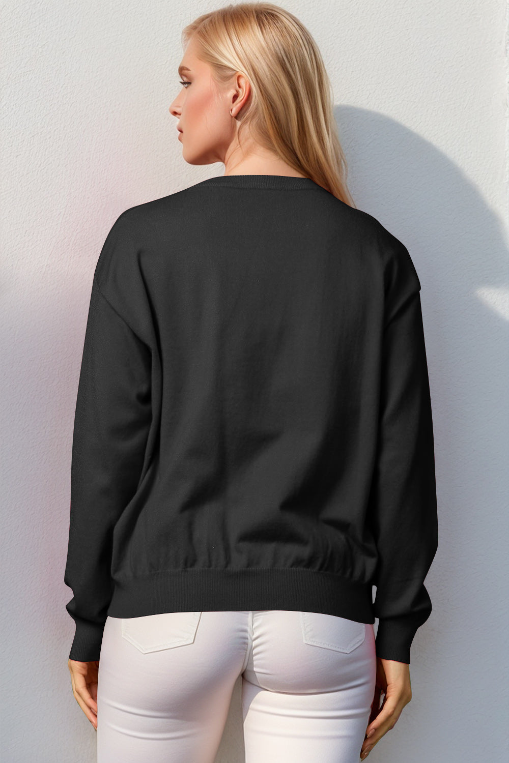 Black crewneck sweater with elasticized hem and cuffs, acrylic knit.