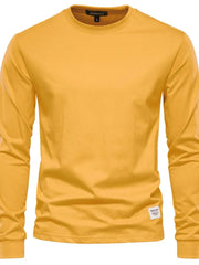 Gold long sleeve crewneck t-shirt with a small woven label on the hem.