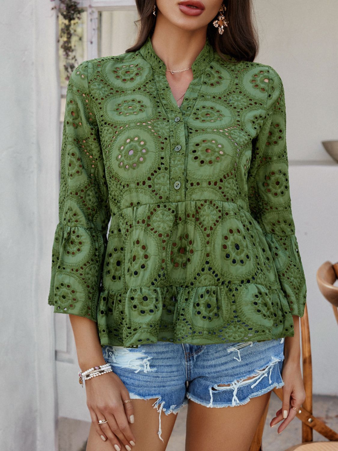 Moss green eyelet embroidered peplum blouse with ruffles and bell sleeves.