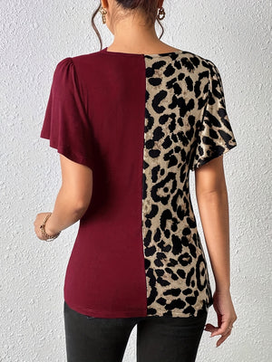 Burgundy and leopard print paneled top with short sleeves and a round neckline.