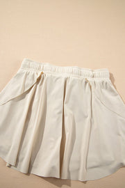 Beige ruffled skort with elastic waist and tie detail
