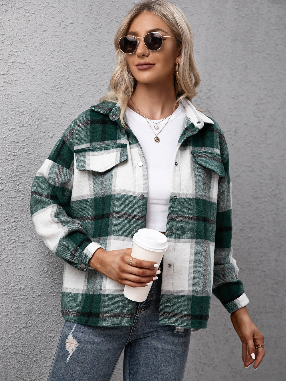 Oversized green plaid button-up shirt with white and dark green checks, featuring two chest pockets.