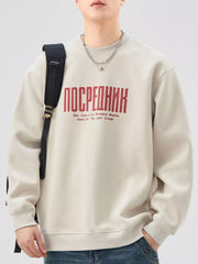 Oversized graphic sweatshirt in apricot cotton blend with red text graphic and crewneck.