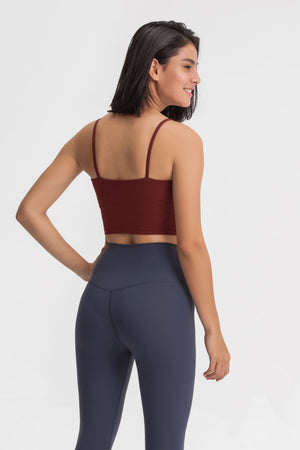 Rust scoop neck crop tank top with thin spaghetti straps.