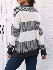 Cozy knit sweater with black and white stripes and a dark grey hem and cuffs.