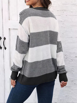 Cozy knit sweater with black and white stripes and a dark grey hem and cuffs.