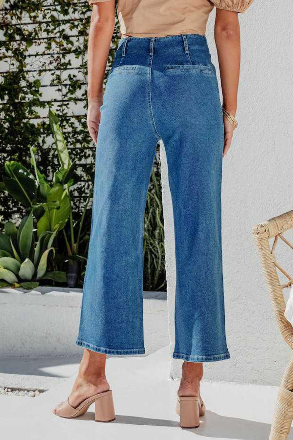 Button-front cropped wide-leg jeans in light blue denim.