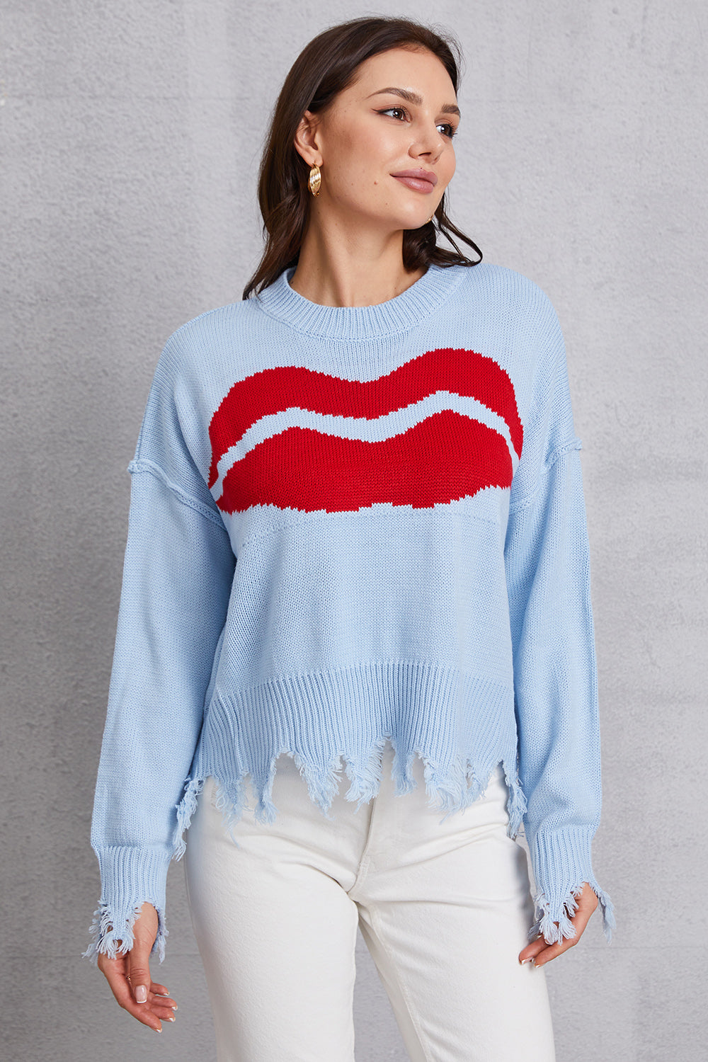 Light blue acrylic sweater with red kiss graphic and distressed hem